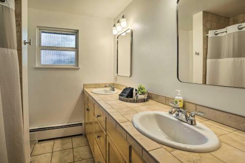 a bathroom with two sinks and a mirror at Lakefront Seattle Area House with Private Deck! in Lynnwood
