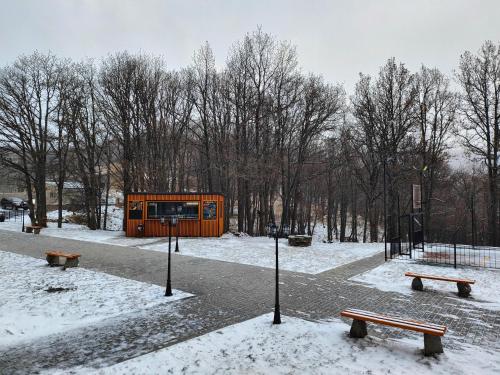 an orange building in a park in the snow at Tsaghkadzor Kechi Apartment 136 in Tsaghkadzor