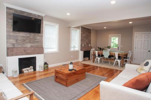 a living room with a couch and a fireplace at Farmhouse Broad Brook: Comfort & Charm. in East Windsor