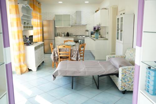 a kitchen and dining room with a table and chairs at La casa nel Parco**** in Torre Annunziata