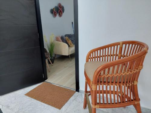 a wooden chair in a room with a living room at Hostal GARDEN ROUS in Paiporta