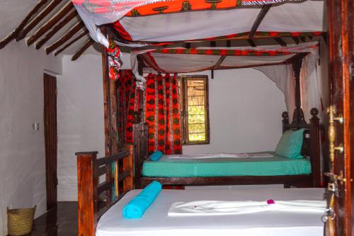 Postel nebo postele na pokoji v ubytování Sagando Bungalows Zanzibar