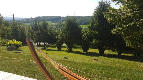 a hammock in a field of grass with trees at La Coste Blanque in Montaut