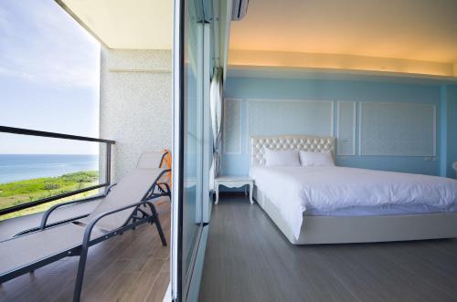 a bedroom with a bed and a balcony at Whitecaps B&B in Yanliau