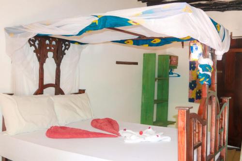 Postel nebo postele na pokoji v ubytování Sagando Bungalows Zanzibar