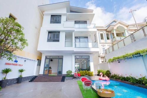 a house with a swimming pool in front of it at Minh Phước Villa 12 Kim Ngân in Vung Tau