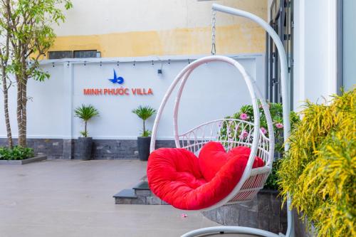 a red heart cushion in a swing in a garden at Minh Phước Villa 12 Kim Ngân in Vung Tau