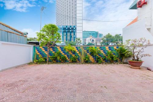 a patio with a fence and plants and a building at Minh Phước Villa 12 Kim Ngân in Vung Tau