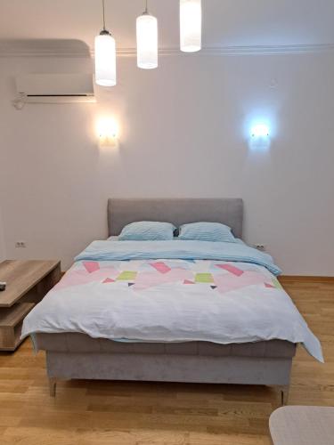 a bedroom with a bed with pink hearts on it at Apartment Bono 2 City Kvart in Podgorica