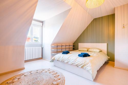 a bedroom with a bed in a attic at Grande maison avec piscine et jacuzzi à la campagne in Desvres