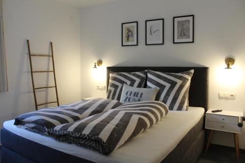 a bedroom with a bed with striped pillows on it at Chasa Patria in Ischgl