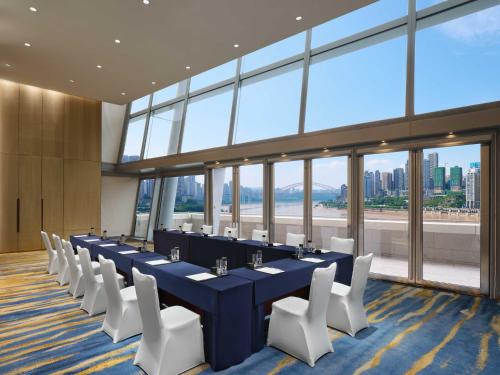 a conference room with a long table and white chairs at InterContinental Chongqing Raffles City by IHG in Chongqing