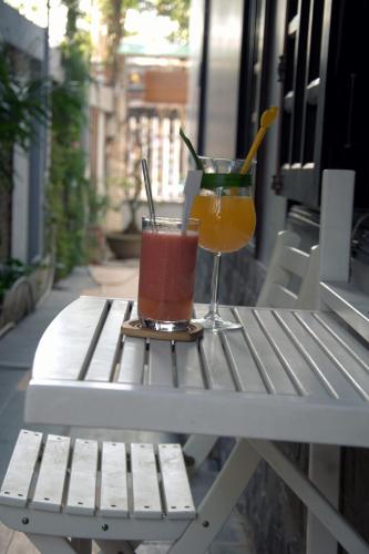 two drinks sitting on a table on a patio at Green CoCo HomeStay in Hoi An