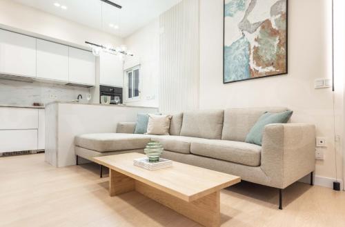 a living room with a couch and a coffee table at NEW Sophisticated apartment with balcony & city views by REMS in Málaga