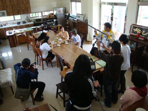 a group of people standing around a table in a room at Taroko Sialin Coffee Farm Homestay in Xiulin