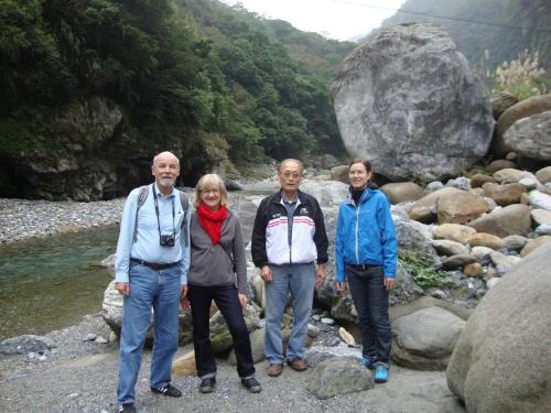 a group of people standing on rocks near a river at Taroko Sialin Coffee Farm Homestay in Xiulin