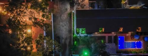 a view of a city at night with green lights at Pousada Vila Mangaba in Arraial d'Ajuda