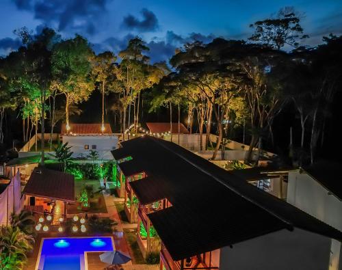 an aerial view of a house with a pool and trees at Pousada Vila Mangaba in Arraial d'Ajuda