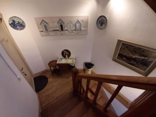 a room with a staircase with plates on the wall at LE DEUX GAULLE in Le Mêle-sur-Sarthe