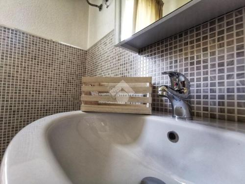 a bathroom with a white bath tub with a sink at Casa Arborea in Castelsardo