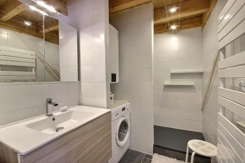 a white bathroom with a washing machine and a sink at Chalet La Plagne Montalbert 50m des pistes in La Plagne Tarentaise