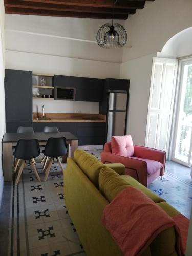 a living room with a couch and a table at CASA PALACIO CABALLEROS 7 con Parking in Sanlúcar de Barrameda