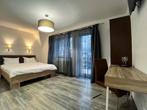 a bedroom with two beds and a window at Pensiunea Mirage in Iaşi
