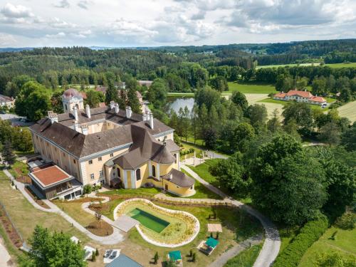 an aerial view of a large house with a garden at Schlosshotel Rosenau Superior in Schloss Rosenau