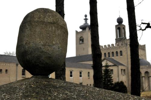 a large stone sculpture in front of a building at Leerhotel Het Klooster in Amersfoort