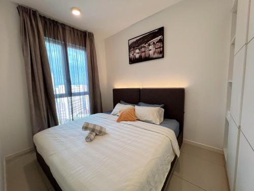 a bed in a room with a large window at The Shore Melaka in Melaka