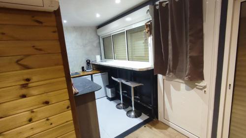 a small kitchen with a sink and a window at Sunset Sapphire in Case-Pilote