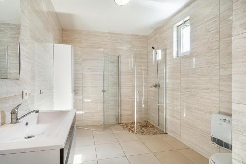 a bathroom with a shower and a sink at Domek v Podještědí in Januv Dul