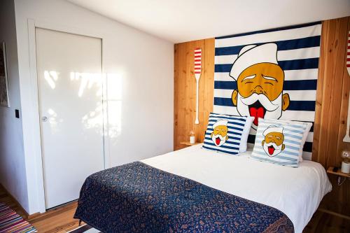 a bedroom with a bed with a chef headboard at Beach House in Lège-Cap-Ferret