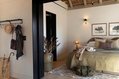 a bedroom with a bed in a room with a door at Monwana in Thornybush Game Reserve