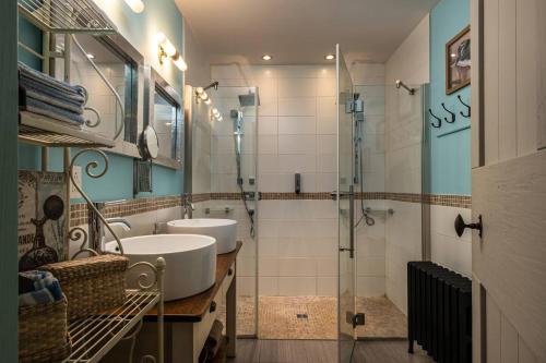 a bathroom with two sinks and a glass shower at CHALET NAHÉLÉ in Val-des-Lacs