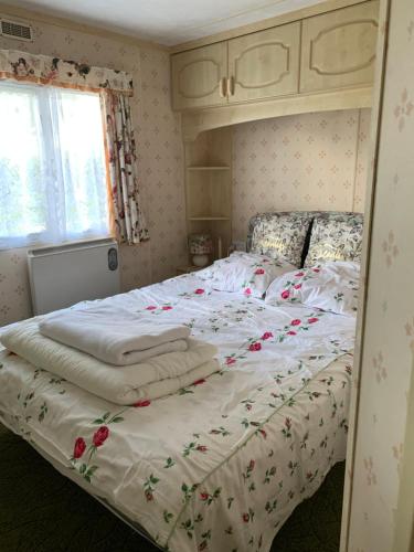 a bedroom with a large bed with flowers on it at Kundziņi in Bīriņi
