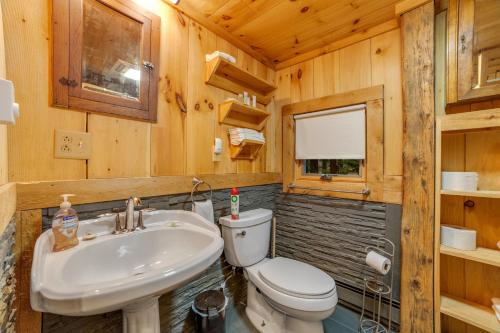 a bathroom with a white toilet and a sink at Stratton Woods in West Wardsboro