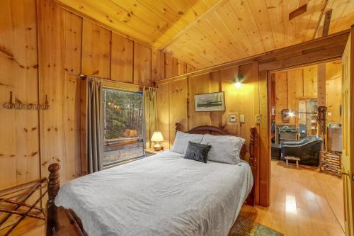 a bedroom with a bed in a room with wooden walls at Stratton Woods in West Wardsboro