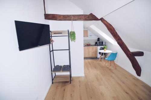a living room with a tv and a table at Studios Lsquare Residence AFPA in Châtellerault