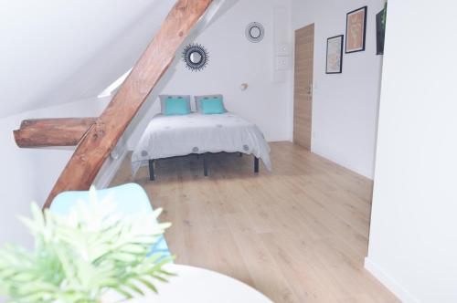 a bedroom with a bed with blue pillows at Studios Lsquare Residence AFPA in Châtellerault