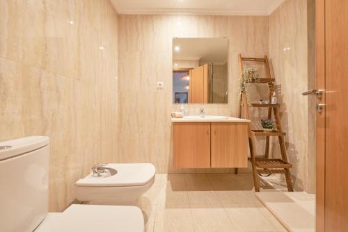 a bathroom with a toilet and a sink at Apartment with Private Terrace & Car Garage in Lisbon