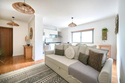 a living room with a couch and a kitchen at Apartment with Private Terrace & Car Garage in Lisbon