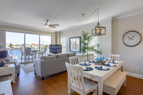 a dining room and living room with a table and a clock at 204 Bay Harbor in Clearwater Beach