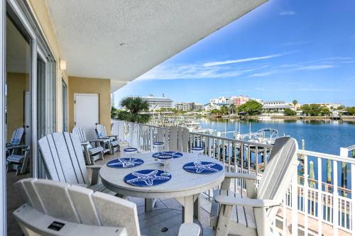 a balcony with tables and chairs with a view of the water at 204 Bay Harbor in Clearwater Beach