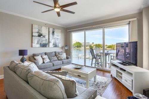 a living room with a couch and a flat screen tv at 204 Bay Harbor in Clearwater Beach