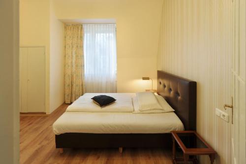 una camera con letto e finestra di Fair Hotel Villa Diana a Francoforte sul Meno