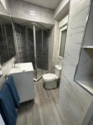 a bathroom with a toilet and a sink and a shower at Rambla Apartment by the Sea in Alicante