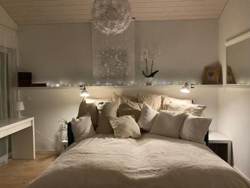 a bedroom with a large bed with white pillows at Le Hameau du Montchervet in Puidoux