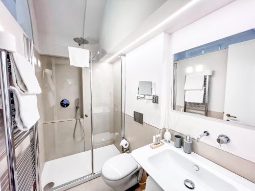 a bathroom with a shower and a sink and a toilet at B&B Palazzo Bruchi in Siena