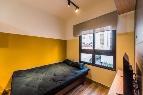 Habitación con sofá y ventana en MI511 - Studio Aconchegante para 4 Pessoas Próximo ao Parque Augusta, en São Paulo